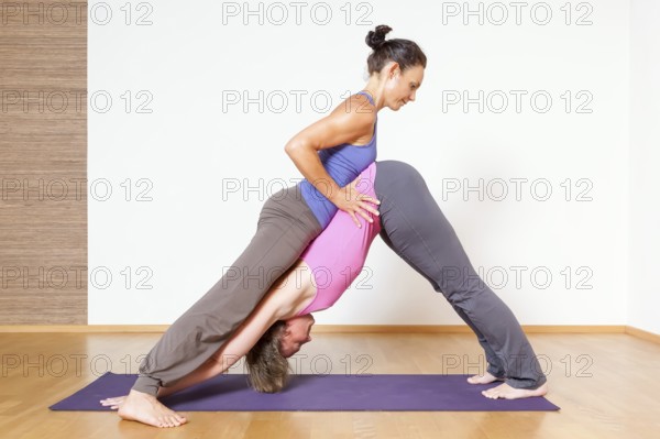An image of some people doing yoga exercises