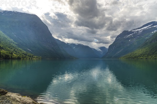 The Kjenndalsbreen is part of the Jostedalsbreen, one of the largest glaciers in Norway, and forms an impressive mountain landscape with a beautiful lake in Sande. The glacier Kjenndalsbreen with a lake in Norway is a beautiful place to travel to in summertime