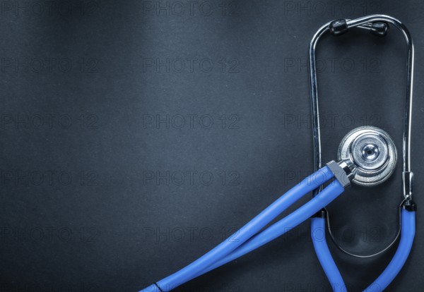 Stethoscope on black background top view medicine concept