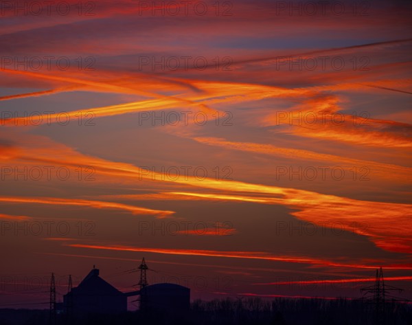 Sunset with red-coloured sky and contrails, Braunschweig, Lower Saxony, Germany, Europe