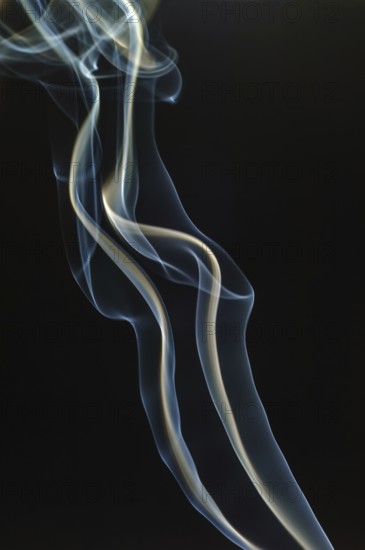 Trajectory of incense smoke in the air showing different shapes. France