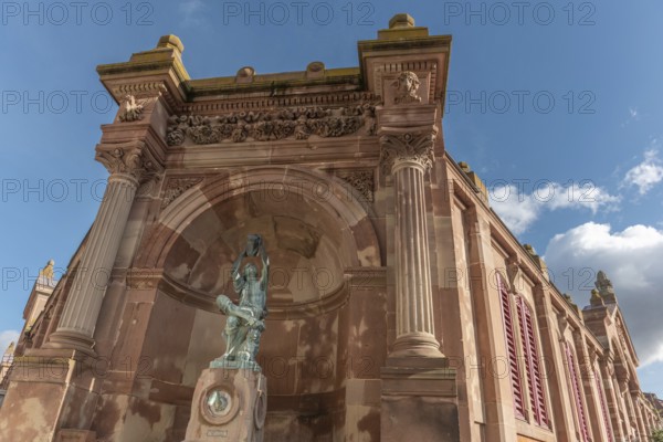 The statue of the winegrower, work of Auguste Bartholdi in front of the covered market in the city of Colmar. Alsace, France, Europe