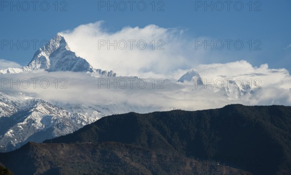 The famous Annapurna massif mountains in the Himalayas covered in clouds, snow and ice in north central Nepal Asia