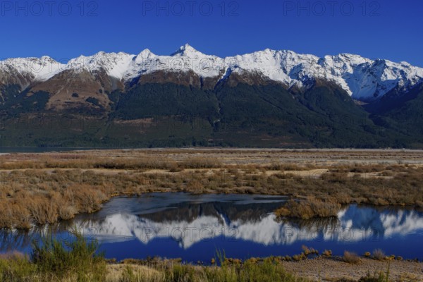 Reflection of snow mountains on lake in Glenorchy, South Island, New Zealand, Oceania