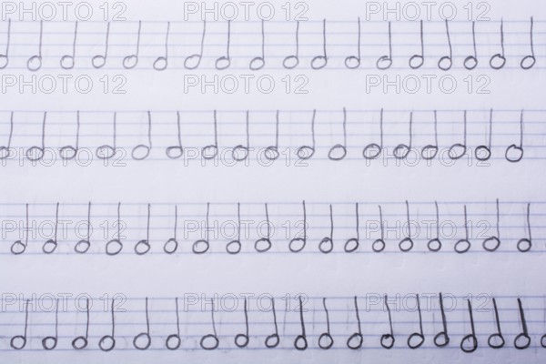 Hand written musical notes are found on paper