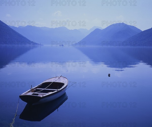 Rowing boat on the lake, evening mood, foggy atmosphere