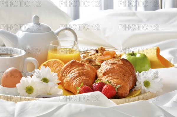Breakfast tray in bed in hotel room