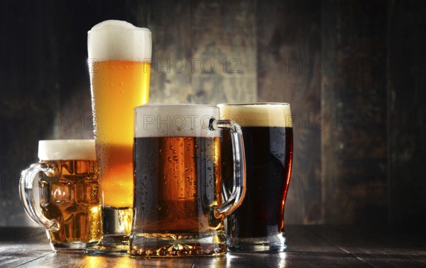 Four glassed of beer on wooden background