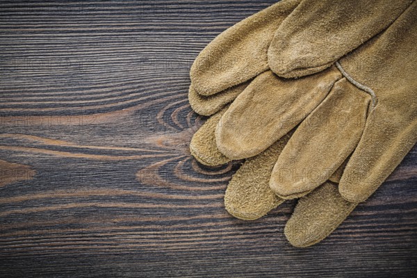 Leather safety gloves on wooden board gardening concept