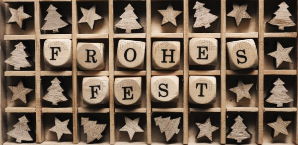 Wooden box with the German words Merry Christmas and small tree and star shapes
