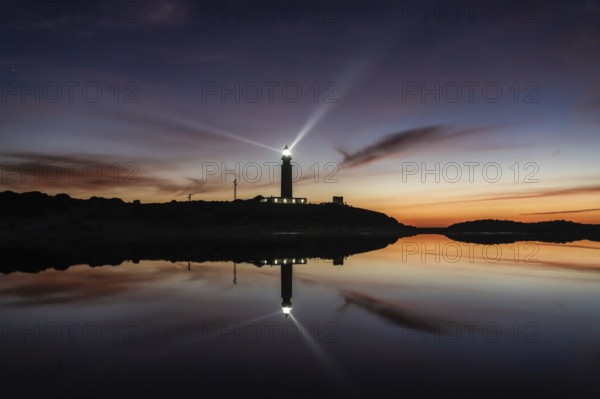 A view of the Cape Trafalgar lighthouse signal light after sunset with colorful evening sky
