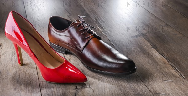 Composition with a high heel women's shoe and a men's shoe