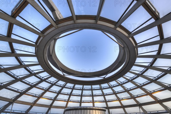 Reichstag in Berlin, the photo shows the dome of the Reichstag with the walkable spiral inside. The architect Norman Foster designed the dome. The glass dome provides the plenum with natural daylight and serves as ventilation. Reichstag building in Berlin. The large glass dome at the very top of the Reichstag has a 360-degree view of the surrounding Berlin cityscape. The main hall of the parliament below can also be seen from inside the dome, and natural light from above radiates down