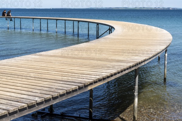 Aarhus, Denmark - 8 June, 2021: a couple enjoys a relaxing afternoon and the amazing views from the Infinite Bridge in Aarhus