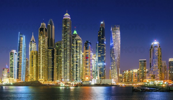 Modern residential architecture of Dubai Marina, United Arab Emirates. City skyline by night