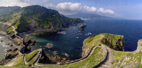 Bakio, Spain - 3 May, 2022: long and winding stone stairs leading up to the Church of San Juan de Gaztelugatxe with a view of the coast of the Spanish Basque Country