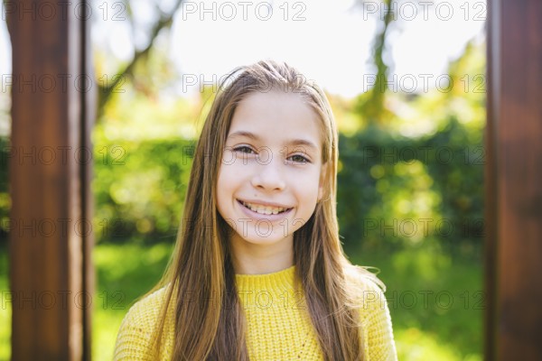 Portrait of modern happy teen girl with braces dressed in yellow clothes in park. Pretty teenage girl wearing braces smiling happily. Nanny in autumn smiling with braces