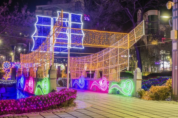 Taebeck, South Korea. January 29, 2019: Boat made of lights constructed on bridge over downtown stream during winter festival