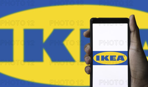 The logo of the IKEA store on the screen of a smartphone.