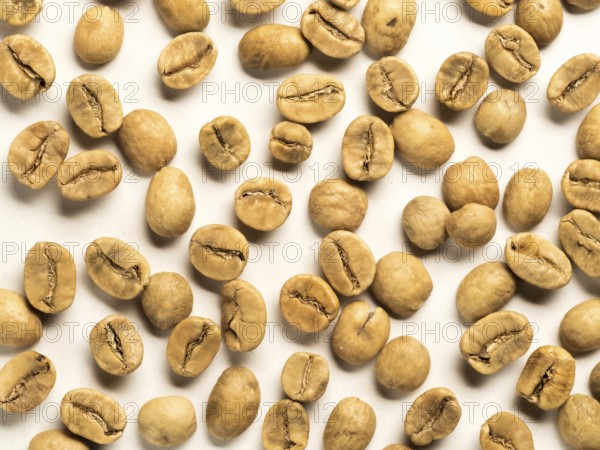 Top view of white coffee beans on white background