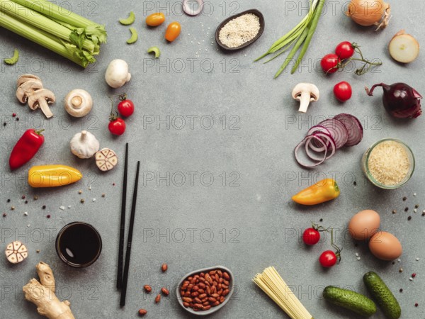 Asian food ingredients with copy space. Various of Chinese cooking ingredients and chopsticks on gray stone background. Asian food concept. Copy space for text. Top view or flat lay