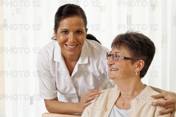 A carer caring for the elderly in a retirement home
