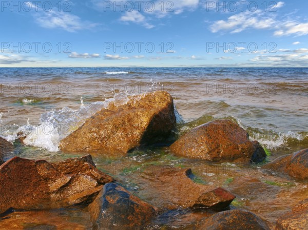 Coastline of the sea with rocks and blue sky over it
