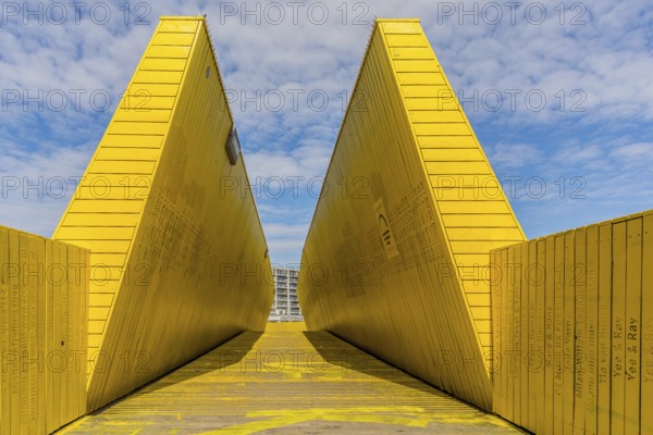 Rotterdam, Netherlands, September 2019: view on the Luchtsingel, a crowdfunded elevated wooden yellow foot bridge, connecting park pompenburg, hofplein and dakakker