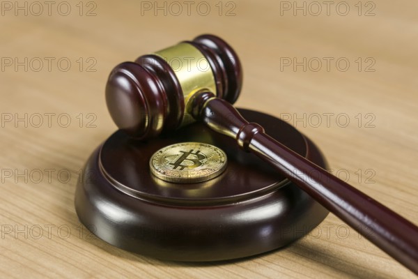 Photo of Bitcoin Regulation. BTC crypto coin and gavel on a desk