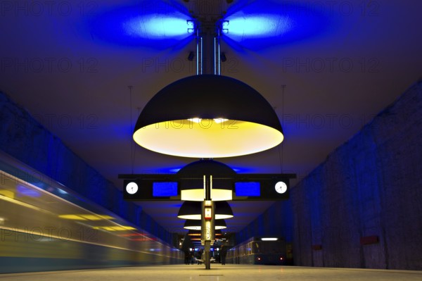 Underground station with arriving trains and symmetrical yellow lights