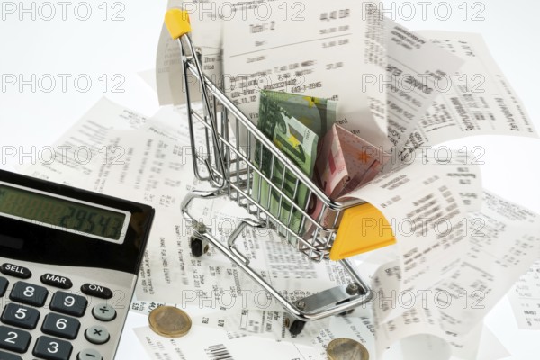 Shopping trolleys, banknotes and receipts, symbolising purchasing power, consumption and inflation Austria
