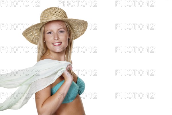 A pretty young woman in summer with a straw hat and bikini is looking forward to her holiday. Austria