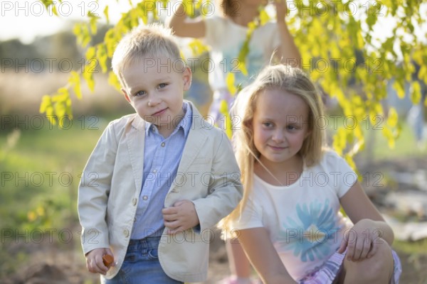Little boy in a suit on the background of his sister