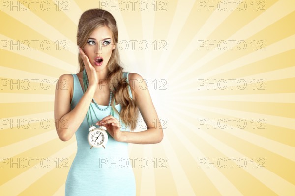 Creative photo of a shocked pin up girl arriving late and holding a retro alarm clock on a colourful cartoon style abstract background