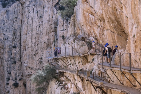 El Chorro, Spain, April 2023: People walking the Caminito Del Rey in the Desfiladero de los Gaitanes, a gorge carved by the Guadalhorce river in the province of Málaga, Spain, Europe