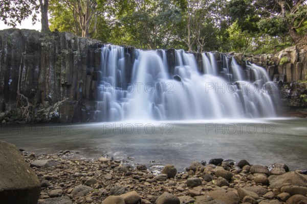 The waterfall is a 10 metre high waterfall that cascades over basal pillars into a basin. Tropical nature and landscape at Rochester Falls, Mauritius, Africa