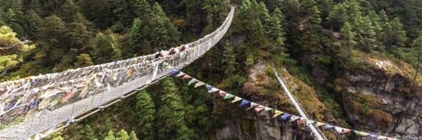 Suspention bridge on the Everest Base Camp Trek, Himalaya mountains, Sagarmatha National Park, Nepal. Web banner in panoramic view