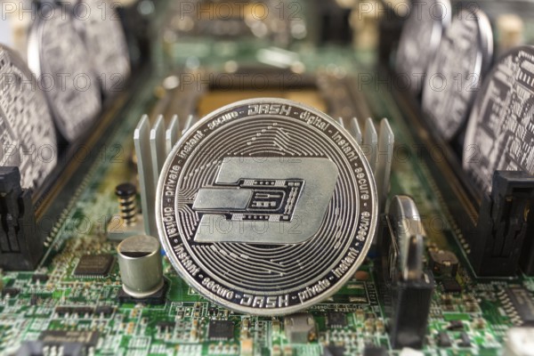 Dash coin close-up on a computer circuit motherboard as a blockchain technology payment network. Digital cryptocurrency concept and mining