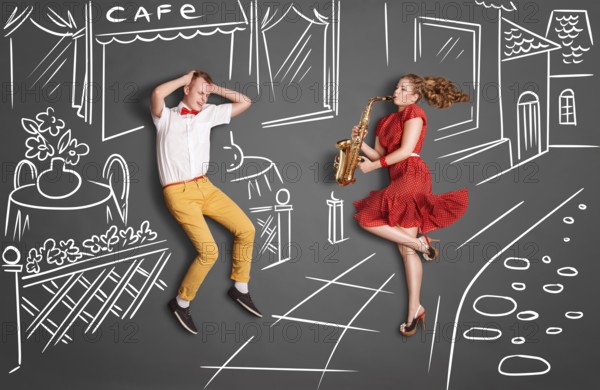 Love story concept of a romantic couple against chalk drawings background. Woman playing the saxophone in the street for her lover