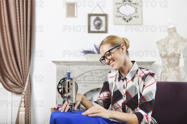 Vintage tailor dressmaker in her studio, old fashion style