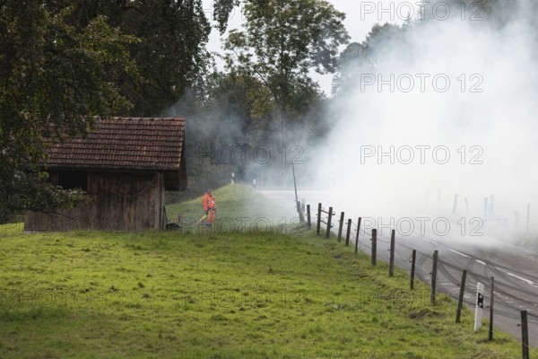 Track marshals in the fog at the 1st Malters hill climb in Malters, Lucerne, Switzerland, Europe