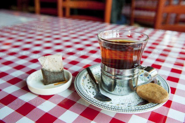 Cup of tea with a cookie in a restaurant