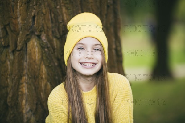 Cute teenage girl with braces smiling happily dressed in bright yellow clothes outdoors. Cute and happy teenage girl with braces smiling at camera. Alignment bite of teeth, correct bite of teeth