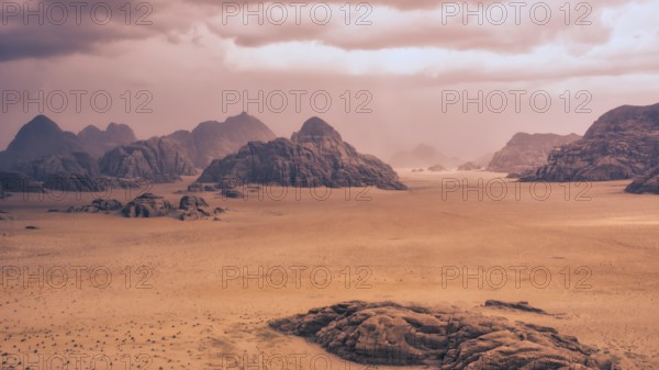 Storm and rain clouds over the desert landscape of Wadi Rum in Jordan. Panoramic shot 16:9 aspect ratio