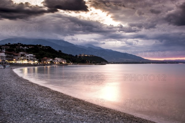Beautiful seascape, amazing view of pebble coastline in mild sunset light, romantic evening on the beach, perfect place for summer holidays