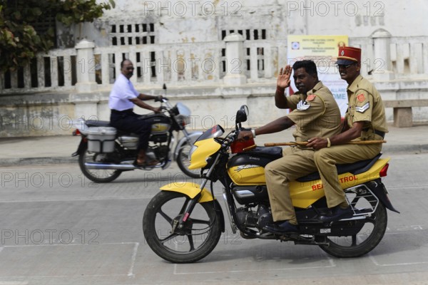 South India, Thanjavur, Madurai, Kovalam, Malabar Coast, Malabar, Kerala, Two policemen on a yellow motorbike riding on a road, Impressions from South India, Thanjavur, Madurai, Kovalam, Malabar Coast, Malabar, Kerala, South India, India, Asia