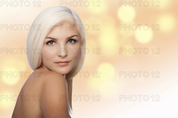 Beautiful face of young woman for Aesthetics facial skincare concept looking over shoulder, on blurred lights background, Atlanta, USA, North America