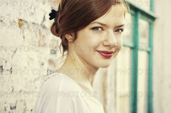 Charming girl teen posing outdoors in bright sunlight