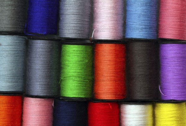 Lot of colored thread spools, background
