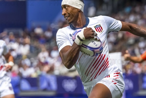 Jul 25, 2024-Paris, FRA, Men?s Pool B Rugby Seven: Team United States back Perry Baker (11) (USA) fights for the ball during the match between Team USA (USA) and Team Uruguay (URU) at the Paris 2024 Olympic Games at Stade de France in Saint-Denis, France. Australia wins the match 14-22